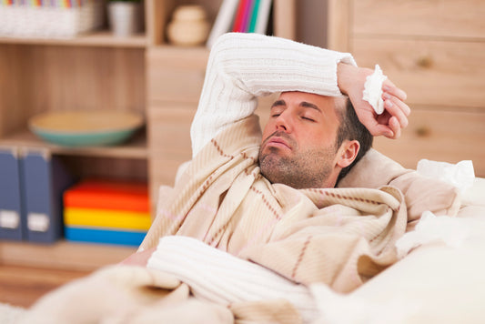A man sick with flu in bed.
