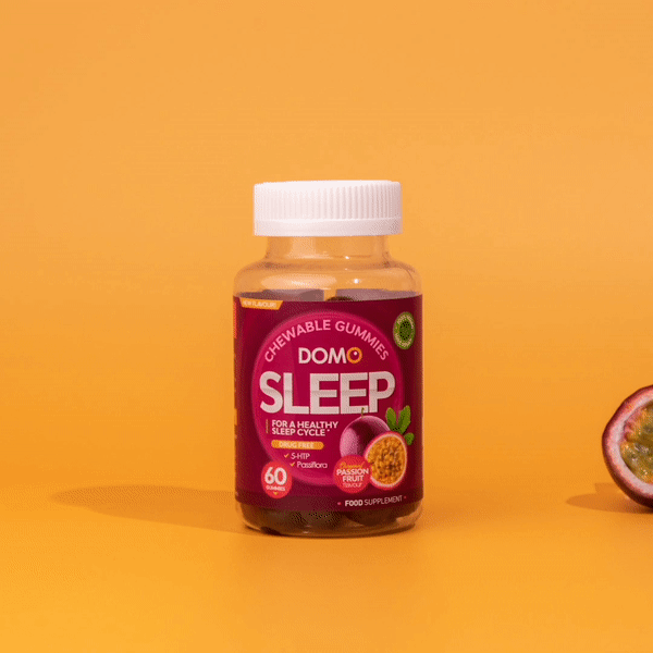 A gif of a passionfruit turning into gummies behind a bottle of Domo Sleep Gummies. 